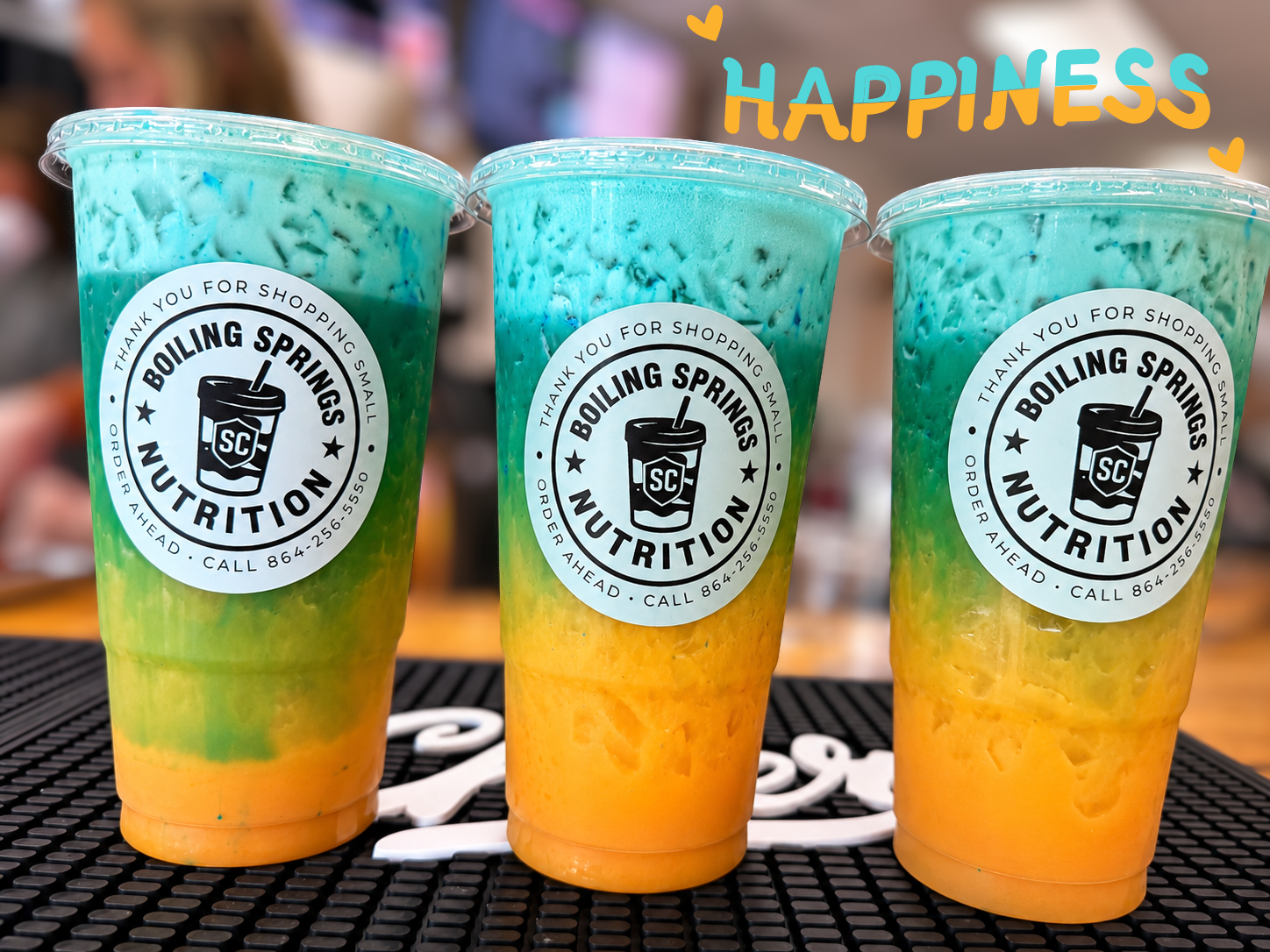 Three colorful original BSN beverages with their authentic cup logos
